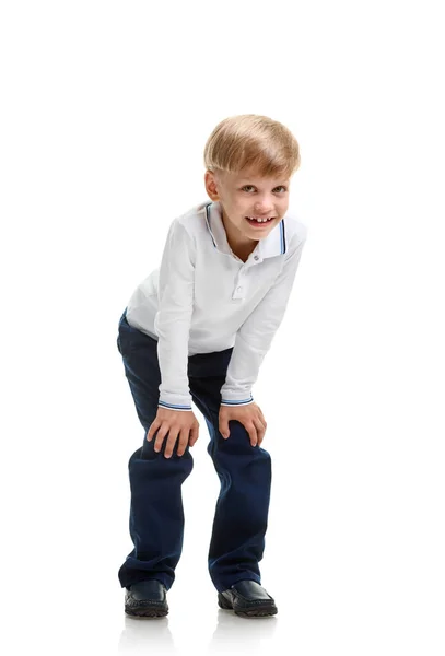 Young schoolboy crouching — Stock Photo, Image
