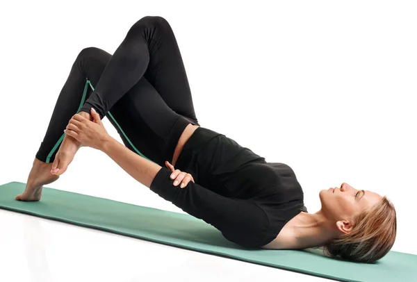 Woman stretching on mat — Stock Photo, Image