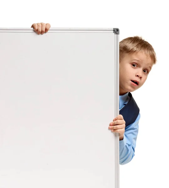 Schoolboy looking out whiteboard — Stock Photo, Image