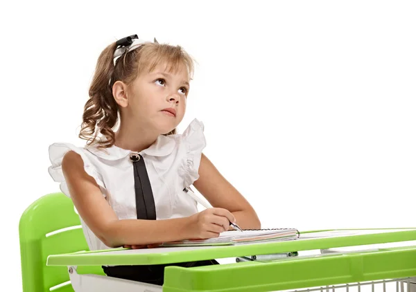 Minded schoolgirl at the desk — Stock Photo, Image