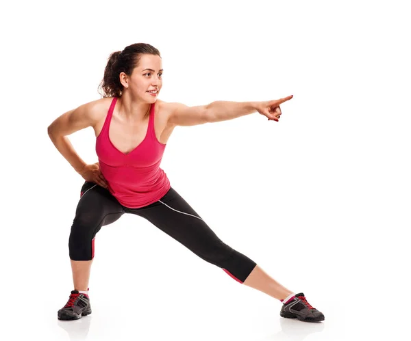 Lunge exercise and pointing woman — Stock Photo, Image