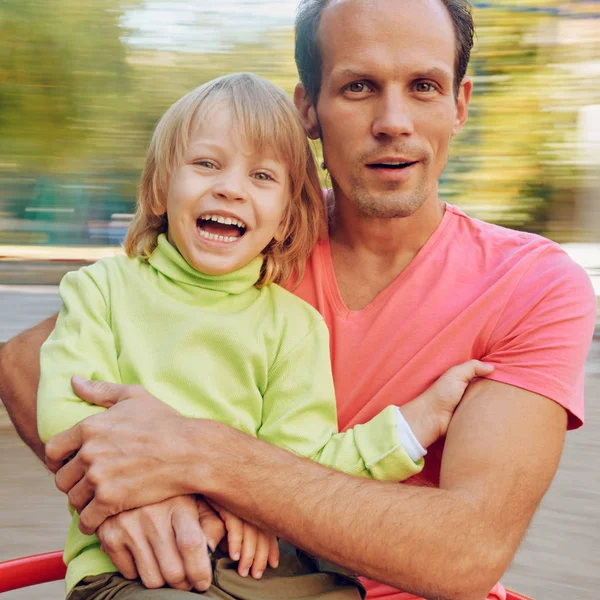 Happy Father and son on carousel — Stock Photo, Image