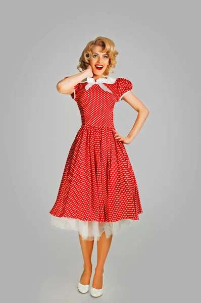 Coquettish retro girl in spotted dress — Stock Photo, Image