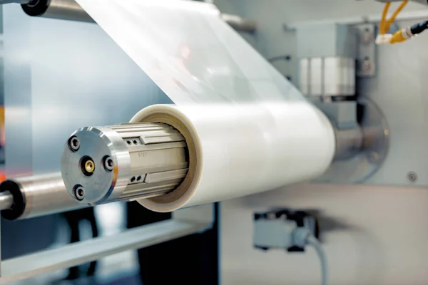 Roll of packaging film. Feeding unit of a modern packaging machine