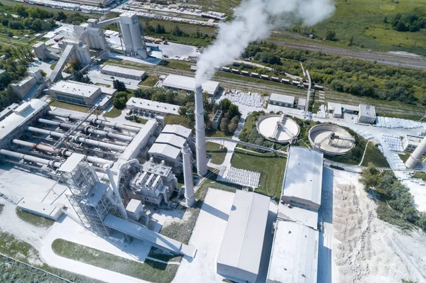 Cement factory, industrial enterprise. The smoking factory chimney.