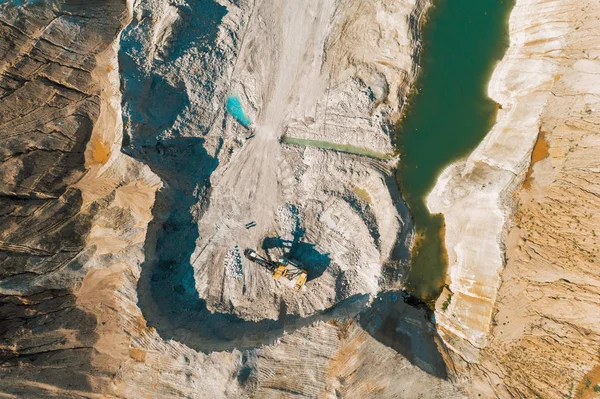 Extraction of minerals by the open method. Mining, extraction of rocks by an excavator. Aerial view