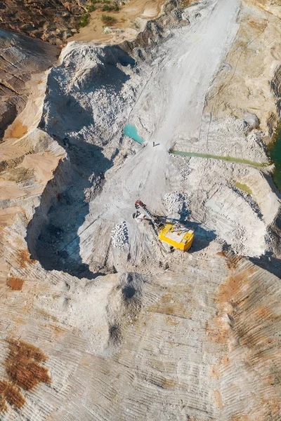 Extraction of minerals by the open method. Mining, extraction of rocks by an excavator. Aerial view