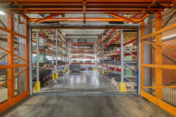 Factory warehouse steel reinforcement. High stacked shelving.