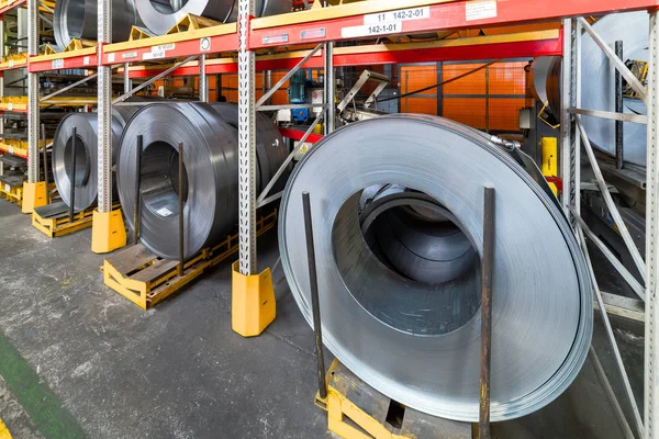 Tiered rack with sheet metal rolls. Internal warehouse of raw materials