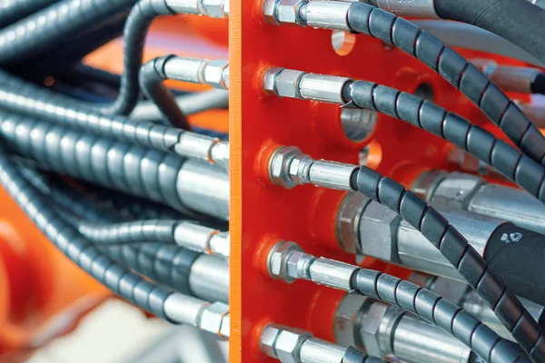 Block hydraulic hoses. High pressure hoses are connected by hydraulic connectors.