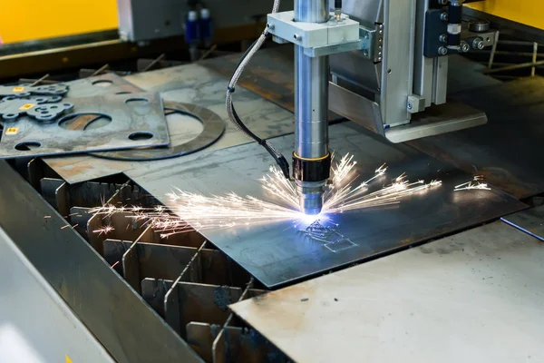 Automatic CNC plasma cutting machine cuts details from steel sheet.