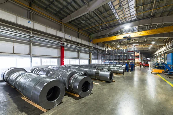 Rolls of sheet metal lie on the floor. Internal warehouse of raw materials