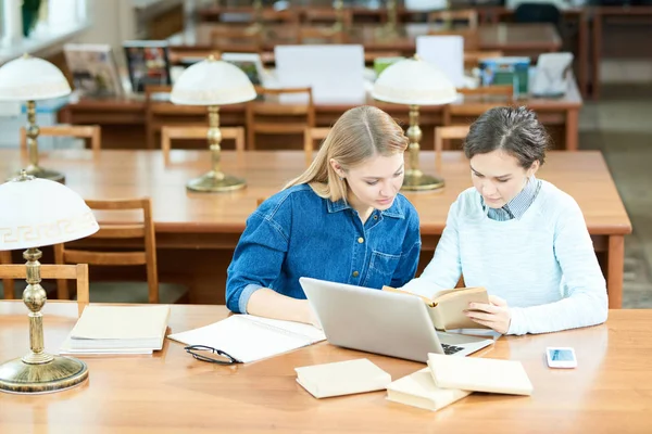 Ocupada Estudante Moderna Concentrada Menina Analisando Livro Didático Usando Laptop — Fotografia de Stock