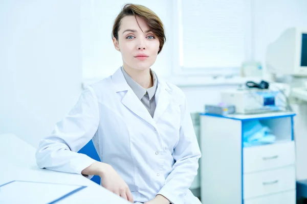 Female Medic White Coat Sitting Desk Office Looking Camera — Stock Photo, Image