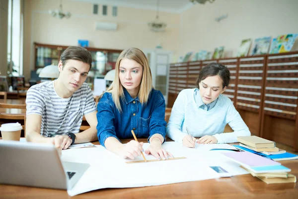 Serious Confident Student Friends Examining Blueprint Library Concentrated Guy Pointing — Stock Photo, Image