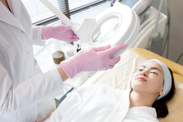 Unrecognizable Beautician Wearing White Coat Rubber Gloves Using Magnifying Lamp — Stock Photo, Image