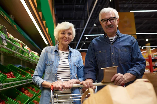 Portret Van Moderne Senior Paar Met Winkelwagentje Poseren Camera Supermarkt — Stockfoto