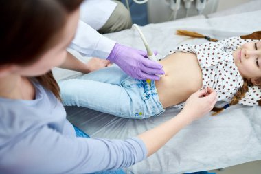 Doktor ekipman ile ürün yakından görmek küçük şirin kız inceliyor