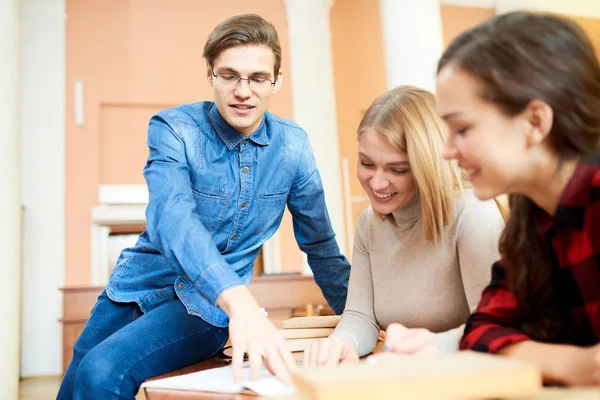 Wesoły Pewnie Inteligentnym Studentem Chłopiec Siedzi Stole Wskazując Stronie Księgi — Zdjęcie stockowe