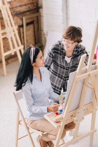 High Angle Portrait Smiling Young Woman Painting Sitting Easel Art — Stock Photo, Image