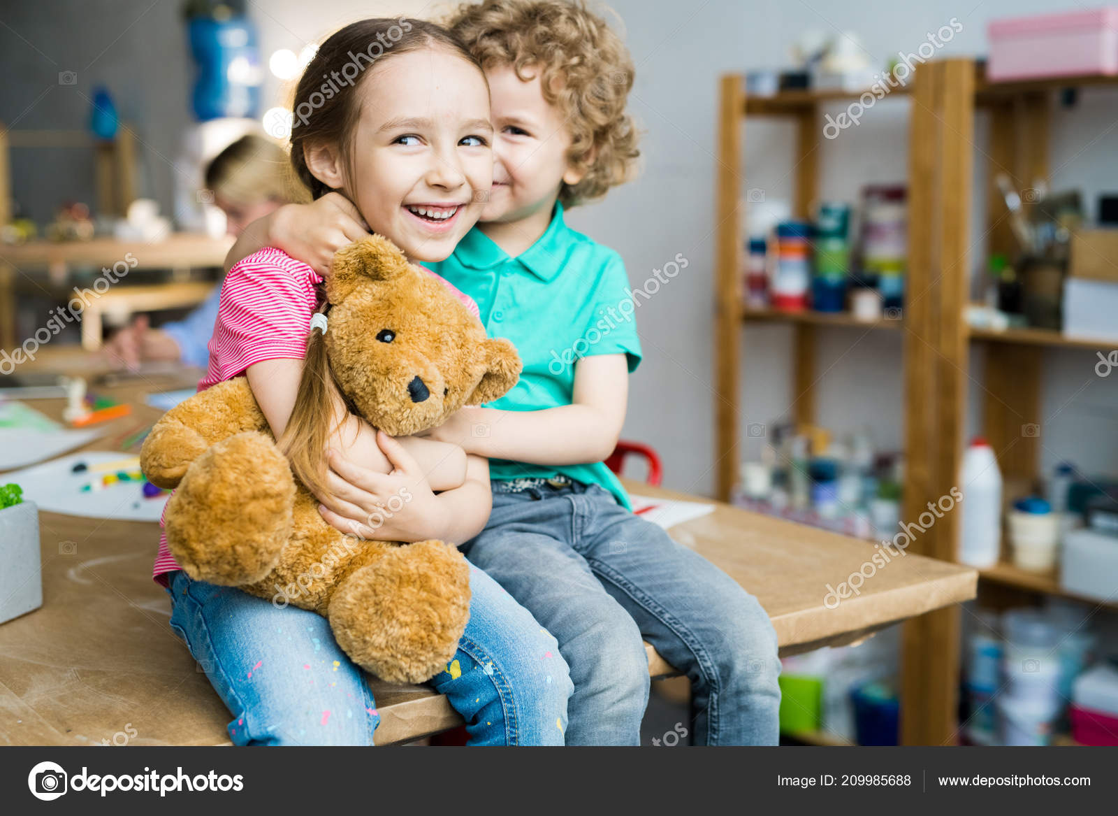 kid hugging teddy bear