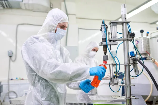 Arbeiter Der Produktion Von Sporternährung Schutzkleidung Bedient Flaschenverschlussmaschine — Stockfoto