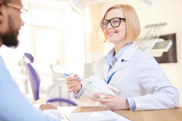 Friendly Blond Haired Dentist Wearing White Coat Eyeglasses Sitting Her — Stock Photo, Image