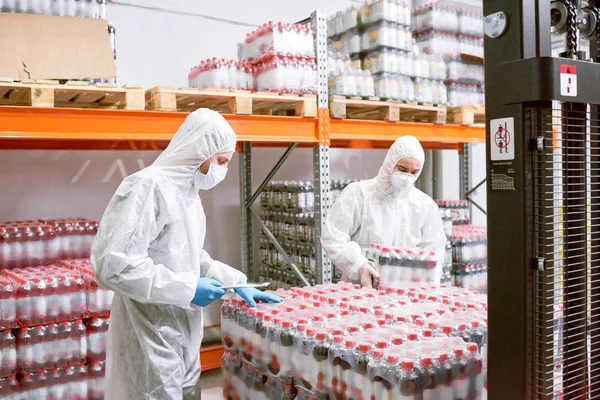 Sports Nutrition Production Employees Protective Clothing Unloading Packs Plastic Bottles — Stock Photo, Image