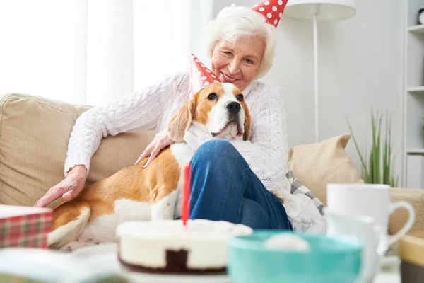 Portrait Happy Senior Woman Hugging Dog Sitting Couch While Celebrating — Stock Photo, Image