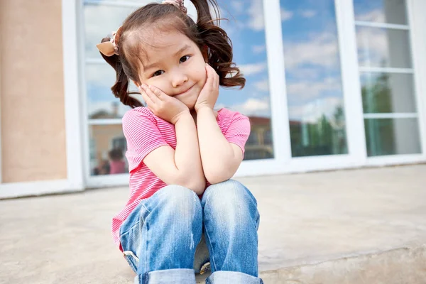 Portret Ładna Dziewczynka Azjatyckich Warkoczykami Pozowanie Siedząc Schodach Zewnątrz Patrząc — Zdjęcie stockowe
