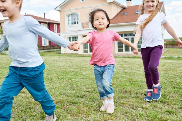 Portrait Three Happy Little Kids Holding Hands Running Green Lawn — Stock Photo, Image