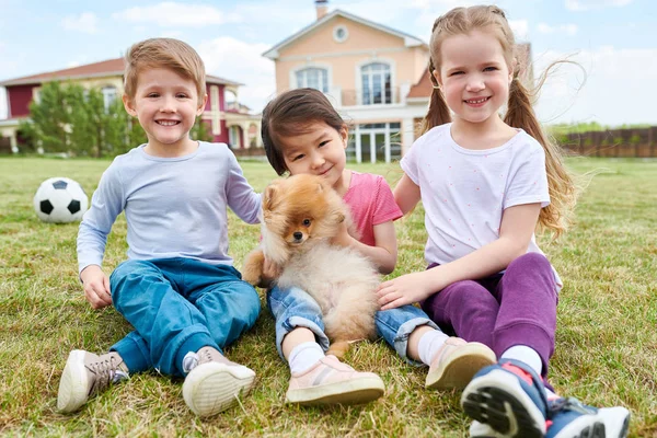 Multi Ethnic Group Kids Posing Together Sitting Green Lawn Playing Stock Picture