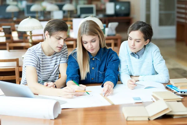 Group Pensive Concentrated Architecture Students Discussing Blueprint While Sitting Table — Stock Photo, Image