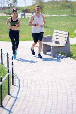 Etkin genç çift Park açık havada çalışan tam uzunlukta portre, kopya alanı