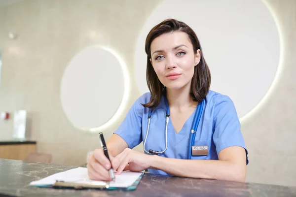 Retrato Del Médico Femenino Mirando Cámara Sonriendo Mientras Trabaja Escritorio — Foto de Stock