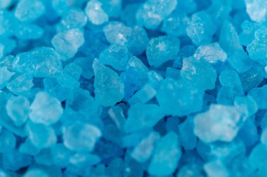 Background macro shot of blue crystals of salt, mineral or chemical reagent, copy space clipart