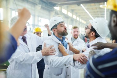Sanayi atölyesinde toplantı sırasında öfkeli işçilerle konuşan iki olgun fabrika yöneticisinin portresi