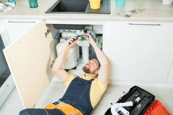 Positiv Vacker Skäggiga Rörmokare Uniform Liggande Flor Och Skär Kablar — Stockfoto