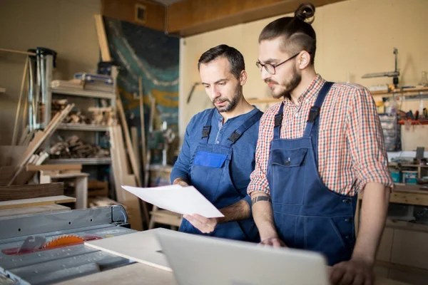 Waist Portrait Two Modern Carpenters Looking Plans While Making Furniture — Stock Photo, Image