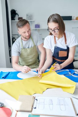 Deri kumaş ile masada çalışan ve yeni ürün yaratan iki tabakçıdan oluşan ekip