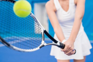 Kapalı mahkeme, kopya alanı spor oynarken tanınmaz tenis oyuncusu raket ile topu vurmak closeup