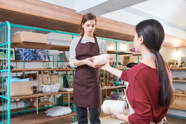 Porträtt Två Unga Kvinnor Som Bär Förkläden Ordna Varor Hyllorna — Stockfoto