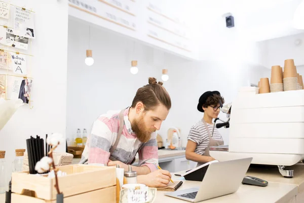 Serious Pensive Handsome Bearded Barista Leaning Counter Checking Orders Notepad — Stock Photo, Image