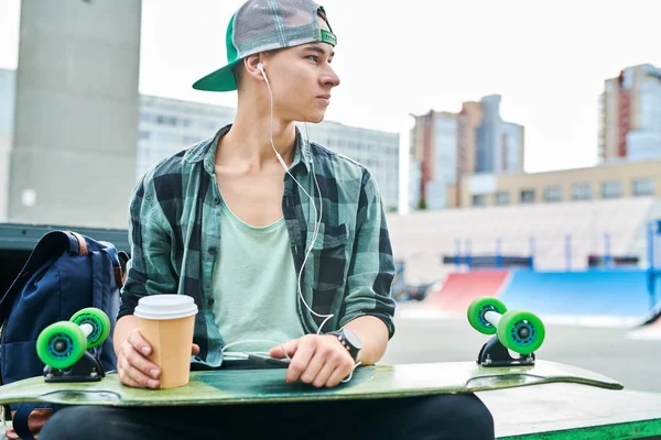 Waist Portrait Contemporary Teenager Sitting Bench Skateboard Park Listening Music — Stock Photo, Image