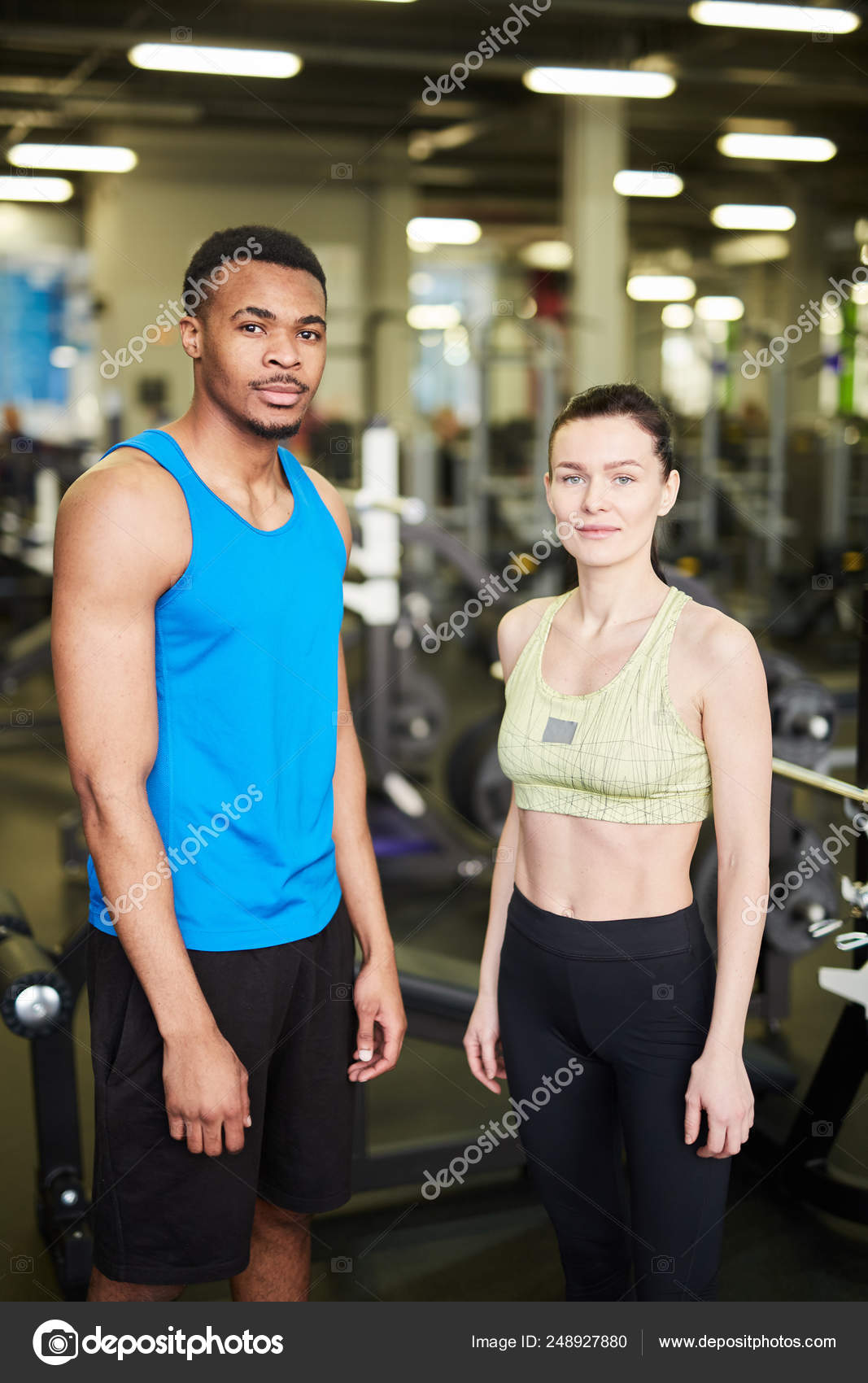 Two Young Professional Sports Trainers Activewear Standing Front Camera