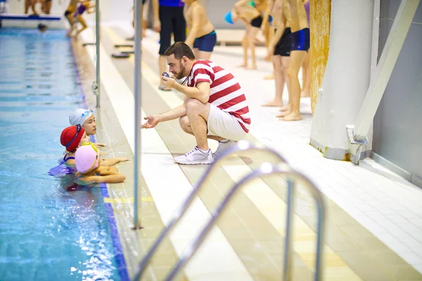 Junger Schwimmlehrer Sitzt Der Nähe Des Beckens Und Hat Eine — Stockfoto