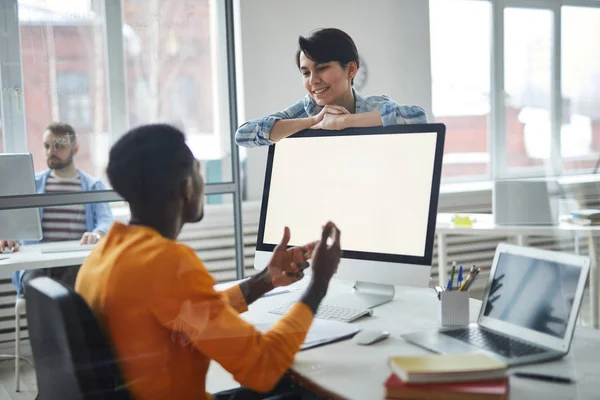 Happy Young Female Manager Leaning Computer Monitor While Looking Her — Stock Photo, Image