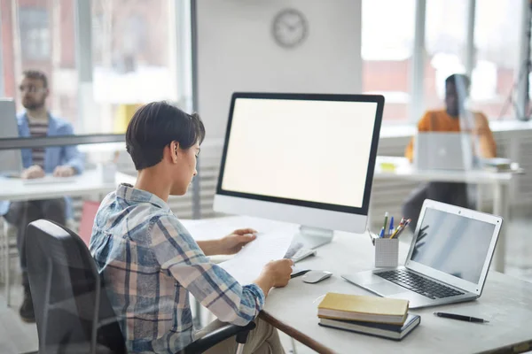 Young Manager Casualwear Looking Business Papers While Sitting Desk Front — Stok fotoğraf