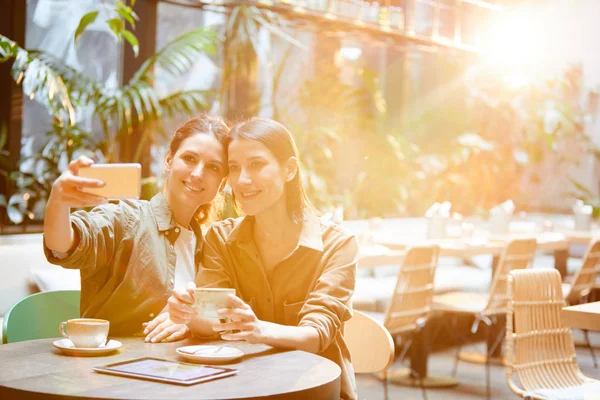 Positive Pretty Young Women Casual Clothing Sitting Table Tablet Cups — Stock Photo, Image