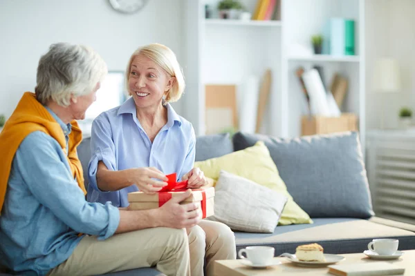 Portrait Contemporary Mature Couple Exchanging Gifts Home Focus Woman Unwrapping — Stock Photo, Image